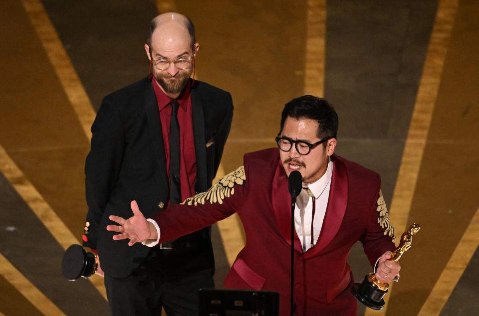 Daniel Scheinert and Daniel Kwan accept the Best Original Screenplay award for Everything Everywhere All at Once during the Academy Awards on March 12.