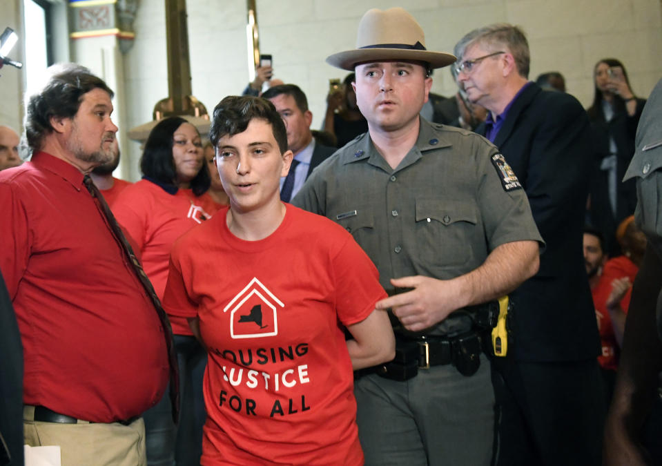 Protesters are arrested by state police as tenants and members of the Upstate Downstate Housing Alliance from across the state, demand New York Gov. Andrew Cuomo and state legislators pass universal rent control legislation that would strengthen and expand tenants rights across the state of New York before rent laws expire on June 15 during a protest rally at the state Capitol Tuesday, June 4, 2019, in Albany, N.Y. (AP Photo/Hans Pennink)