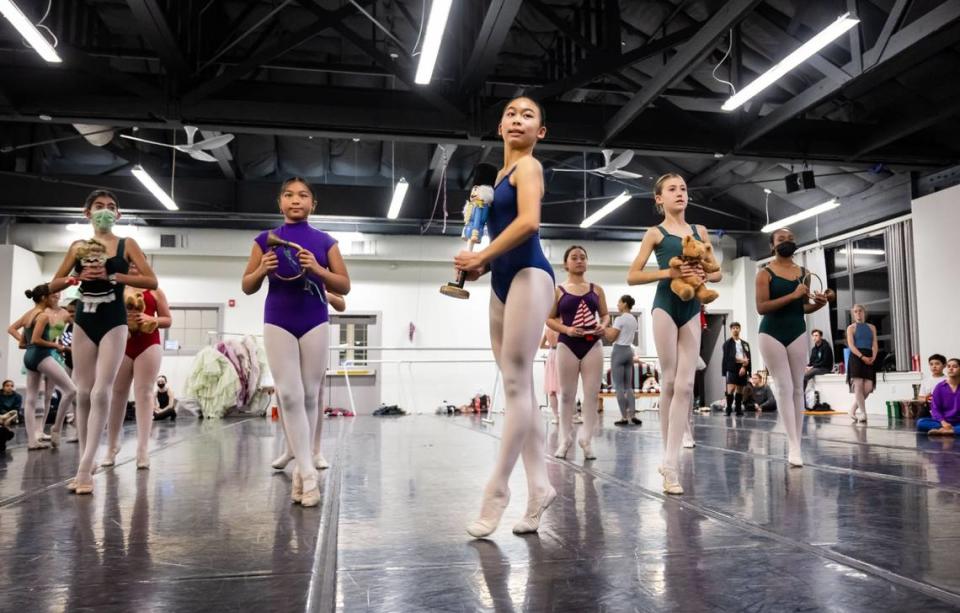 Sabrina Ju, center, 13, rehearses as the lead character “Clara” on Tuesday. “This is the first time that we’ve actually put the whole thing together with the company so it’s a very exciting time,” said choreographer Colby Damon. “Everybody’s all in one space together, so a lot of energy.”