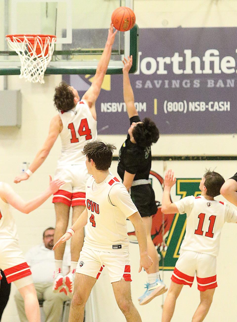 CVU's Tucker Tharpe blocks the shot of Rice's Dallas St.Peter during the Redhawks 42-38 win over the Green Knights in the D1 championship game at Patrick gym on Saturday night.