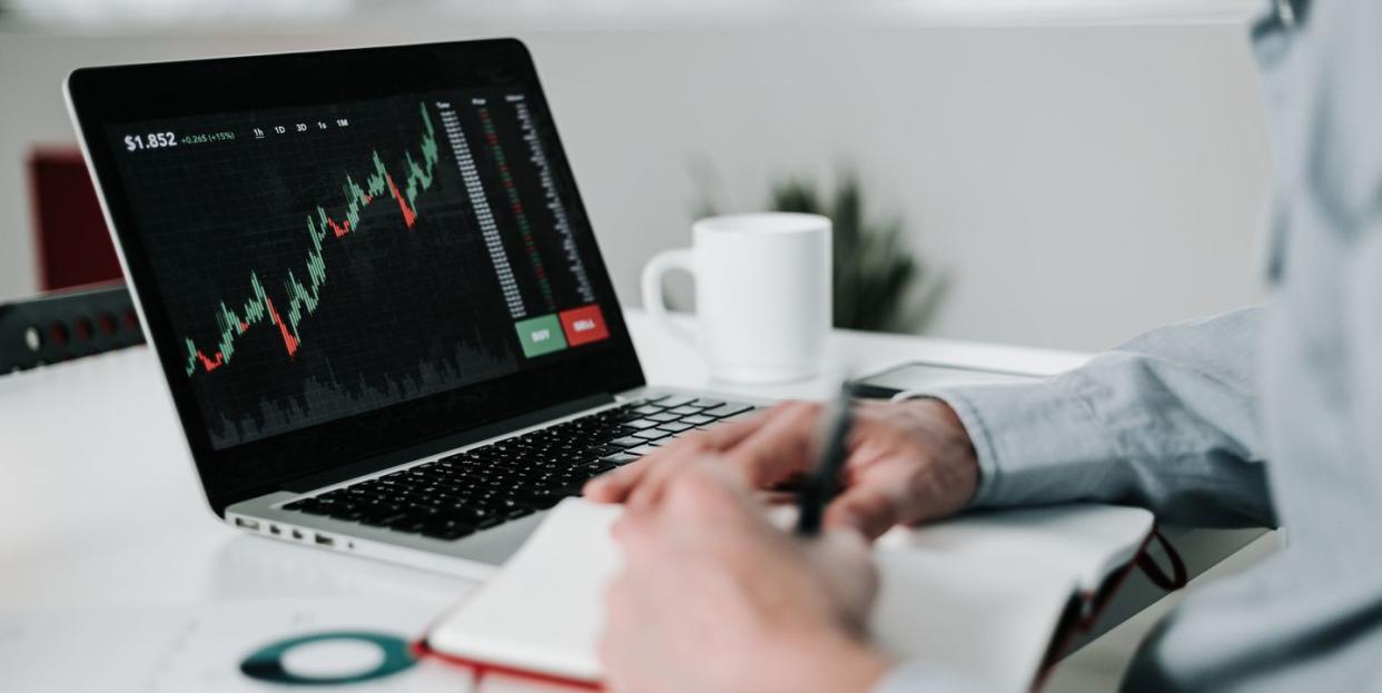 young businessman using laptop for analyzing data stock market