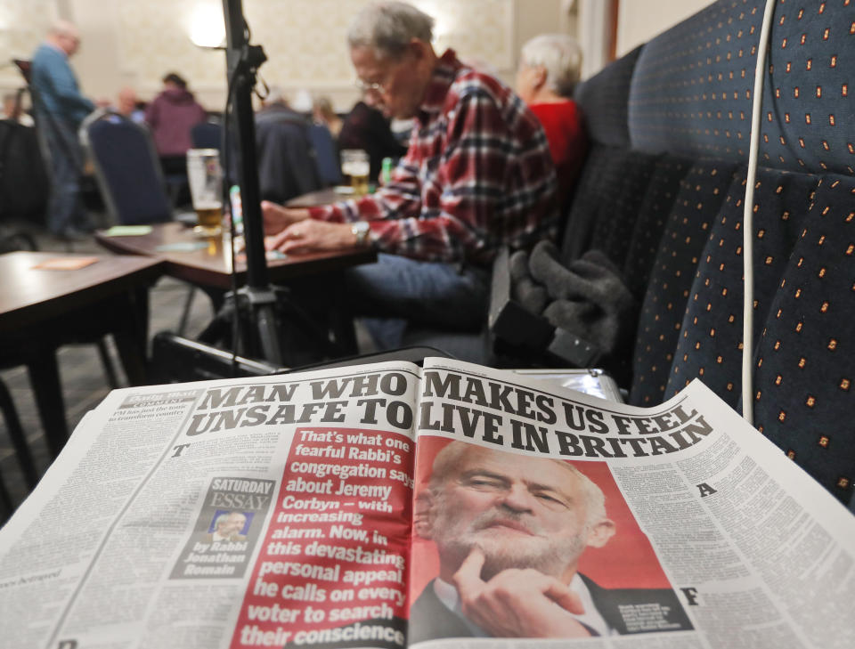 An article critical of Labour Party leader Jeremy Corbyn is displayed as people play bingo at the Hartlepool Working Men's club in Hartlepool, England, Sunday, Nov. 10, 2019. Britain's political parties are battling to win Hartlepool and places like it: working-class former industrial towns whose voters could hold the key to 10 Downing Street, the prime minister's office. Hartlepool has elected lawmakers from the left-of-center Labour Party for more than half a century. But in 2016, almost 70% of voters here backed leaving the European Union.(AP Photo/Frank Augstein)