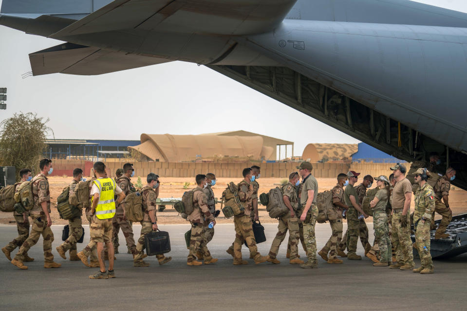 French Barkhane force soldiers who wrapped up a four-month tour of duty in the Sahel board a US Air Force C130 transport plane, leave their base in Gao, Mali Wednesday June 9, 2021. France has suspended joint military operations with Malian forces until the junta led by Col. Assimi Goita, who retook control of Mali's transitional government May 24, complies with international demands to restore civilian rule. (AP Photo/Jerome Delay)