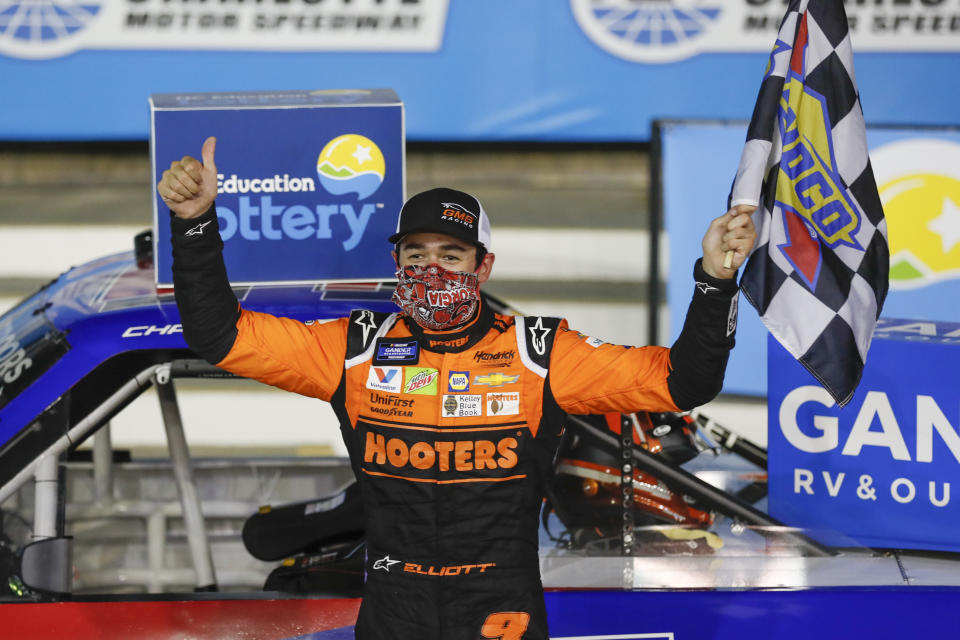 Chase Elliott celebrates after winning the NASCAR Truck Series auto race at Charlotte Motor Speedway Tuesday, May 26, 2020, in Concord, N.C. (AP Photo/Gerry Broome)