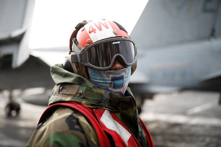 A U.S. Navy crew member works on the deck of U.S. aircraft carrier USS Carl Vinson during an annual joint military exercise called "Foal Eagle" between South Korea and U.S., in the East Sea, South Korea, March 14, 2017. REUTERS/Kim Hong-Ji