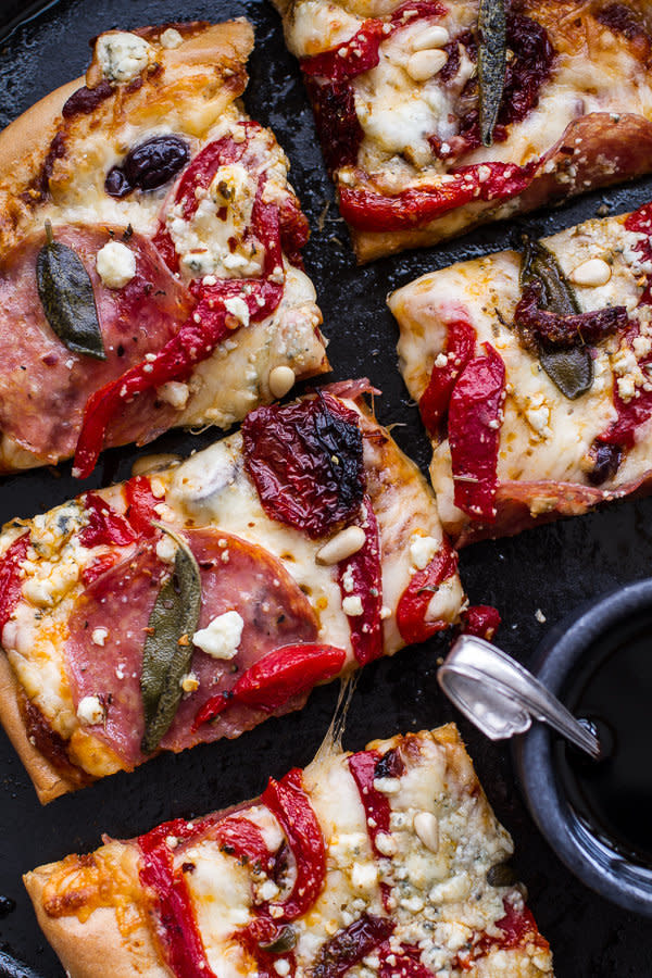 <strong>Get the <a href="http://www.halfbakedharvest.com/sun-dried-tomato-olive-pesto-pizza-salami-roasted-red-peppers/" target="_blank">Sun-Dried Tomato and Olive Pesto Pizza with Salami recipe</a> from Half Baked Harvest</strong>