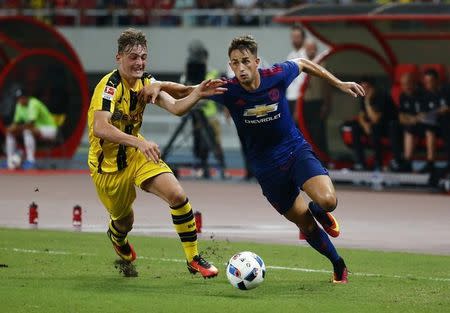 Football Soccer - Borussia Dortmund v Manchester United - International Champions Cup - Shanghai Stadium, Shanghai, China - 22/7/16 Borussia Dortmund's Jacob Bruun Larsen in action with Manchester United's Adnan Januzaj Action Images via Reuters / Thomas Peter / Livepic/ Files