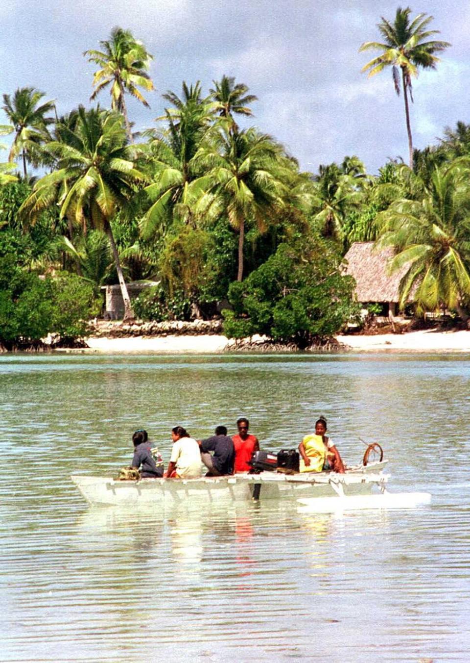 A group of commuters make their way to the island of Kiribati  (AFP via Getty Images)