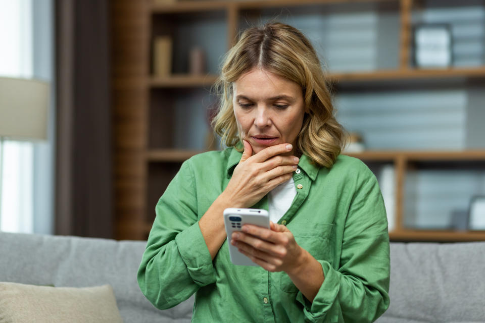 person in shock looking at their phone