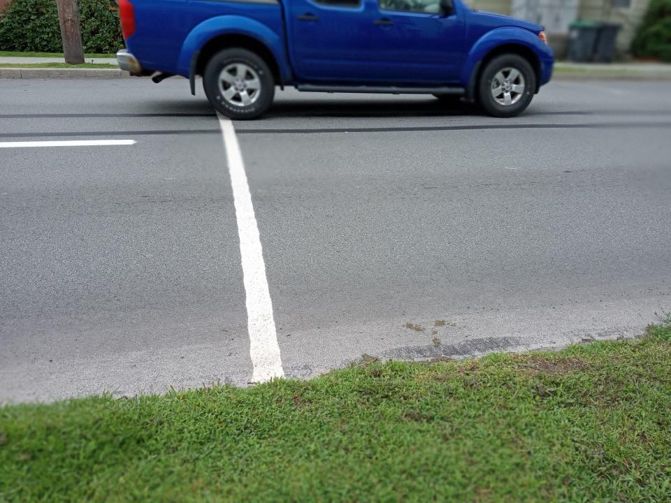 A vehicle passes across one of the two white lines on Church Street that Honesdale Police use to measure speeds of drivers. The speed limit on Church Street is 25 mph.