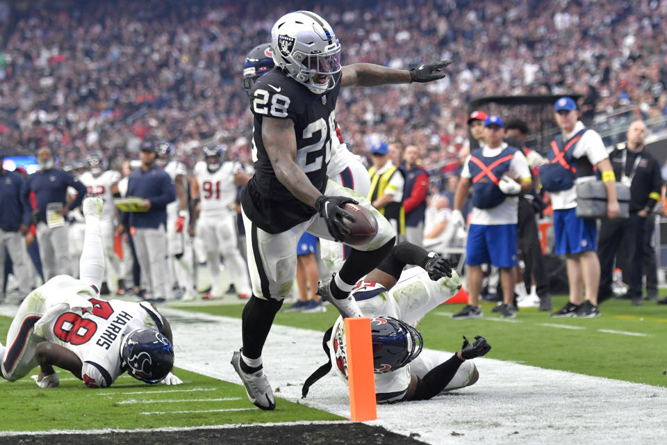Las Vegas Raiders running back Josh Jacobs scores a touchdown during the second half of an NFL football game against the Houston Texans, Sunday, Oct. 23, 2022, in Las Vegas. (AP Photo/David Becker)