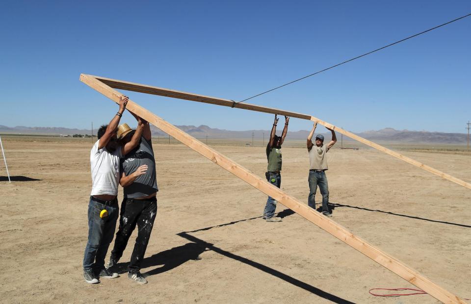 Workers erect a stage at the Little A'Le'Inn on Wednesday, Sept. 18, 2019, in Rachel, Nev: AP Photo/John Locher