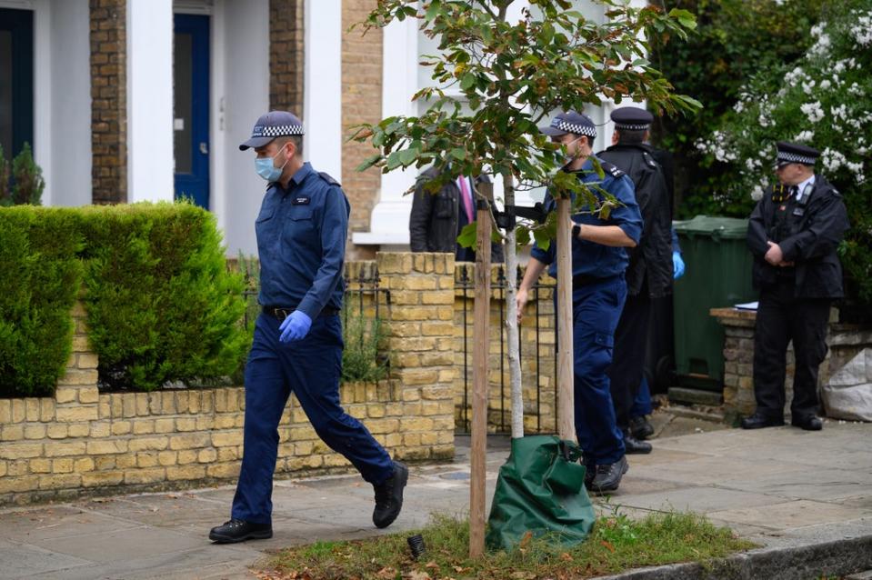 Members of a police search team leave the residence in Kentish Town (Getty Images)