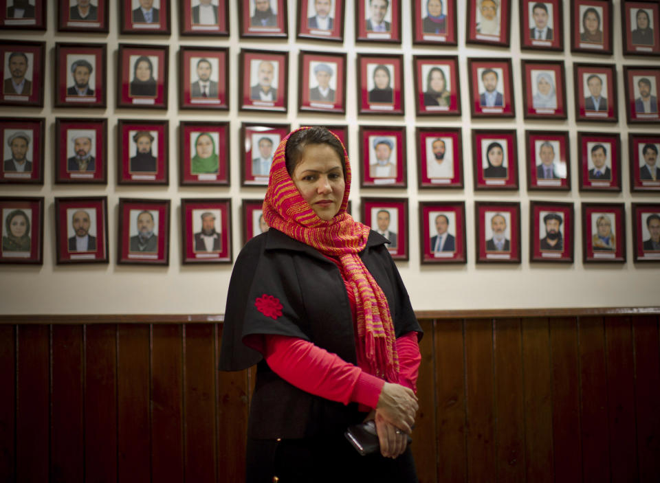 In this Monday, March 17, 2014 photo, Afghan lawmaker Fawzia Koofi from Kabul poses next to the picture wall showing Afghanistan’s 249 parliamentarians in the parliament in Kabul, Afghanistan. Under Afghan law, 20 percent of council member seats are reserved for women, who are also figuring prominently in presidential campaigns. Three presidential hopefuls have taken the bold step of choosing a woman as a running mate, including one of the front-runners. (AP Photo/Anja Niedringhaus)