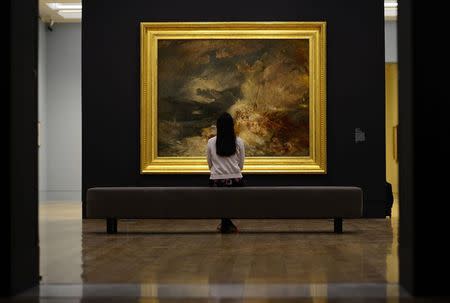 File photograph shows Sara Chan posing for the media as she studies 'A Disaster at Sea' by artist JMW Turner at The Tate Britain in London September 8, 2014. REUTERS/Dylan Martinez/Files