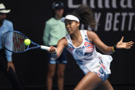 Japan's Naomi Osaka makes a forehand return to China's Zheng Saisai during their second round singles match at the Australian Open tennis championship in Melbourne, Australia, Wednesday, Jan. 22, 2020. (AP Photo/Andy Brownbill)