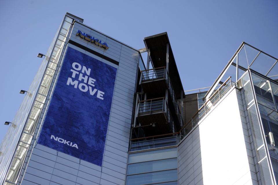 The Nokia headquarters building in Keilaniemi, Espoo, Finland, displays a banner saying they are moving Friday April 25, 2014. Nokia headquarters are "On the move" to join Nokia Solutions and Networks' headquarters in Karakallio, Espoo. Nokia said Friday it has completed the 5.44 billion-euro ($7.5 billion) sale of its troubled cellphone and services division to Microsoft Corp., ending a chapter in the former world leading cellphone maker's history that began with paper making in 1865. The closure of the deal, which includes a license to a portfolio of Nokia patents to Microsoft Corp., follows delays in global regulatory approvals, and ends the production of mobile phones by the Finnish company, which had led the field for more than a decade, peaking with a 40-percent global market share in 2008. (AP Photo/Lehtikuva, Mikko Stig) FINLAND OUT