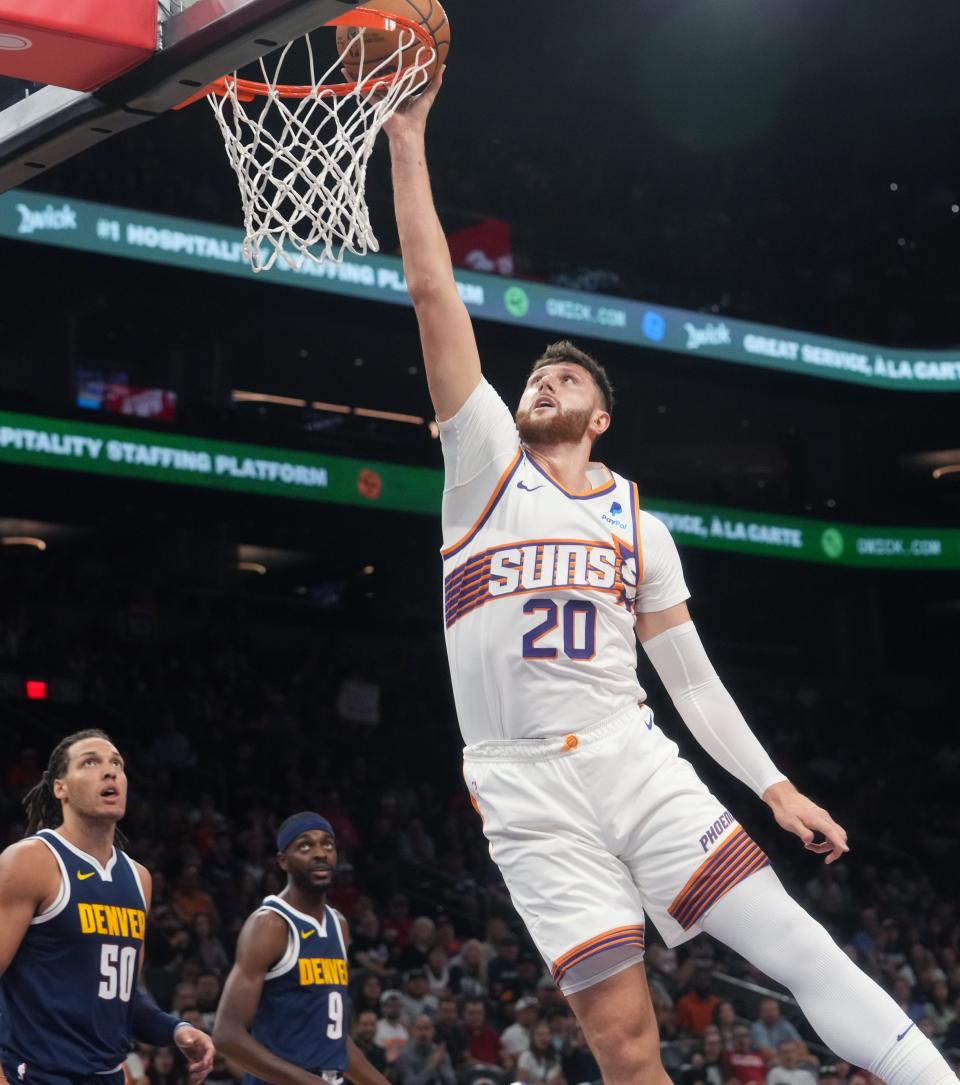 Phoenix Suns center Jusuf Nurkic (27) lays the ball up against the Denver Nuggets at Footprint Center in Phoenix on Oct. 10, 2023.