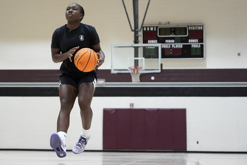 Shay Ijiwoye, who played basketball at Desert Vista High in Phoenix and has committed to Stanford University, works out Monday, March 18, 2024, in Chandler, Ariz. Iowa’s Caitlin Clark has reshaped women's college basketball and the perception of it. Up-and-coming players have taken notice, working to extend their range to be like her. (AP Photo/Matt York)