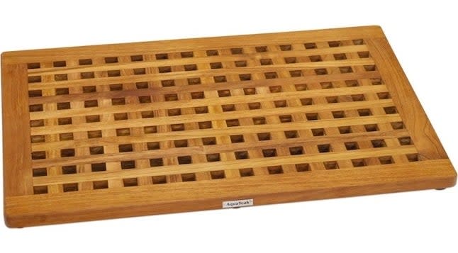 A teak wood bath mat