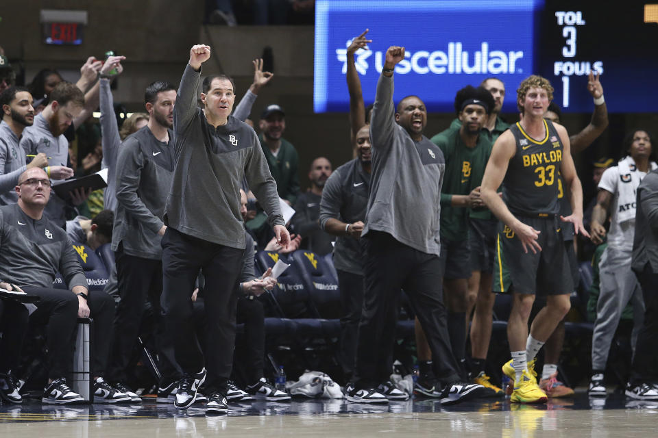 Members of Baylor coaching staff and players react from the bench during the second half of an NCAA college basketball game against West Virginia in Morgantown, W.Va., Wednesday, Jan. 11, 2023. (AP Photo/Kathleen Batten)
