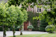 The main house door is seen at the entrance of the Rooksnest estate near Lambourn, England, Tuesday, Aug. 6, 2019. The haziness surrounding the estate hints at one of the challenges for government lawyers as they eye a possible settlement with Purdue Pharma L.P. and its owners, the Sackler family, for their alleged role in flooding communities with prescription painkillers. (AP Photo/Frank Augstein)