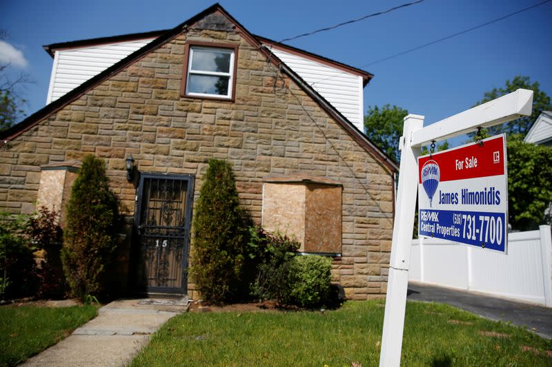 FILE PHOTO: A 'for sale' is seen outside a single family house in Garden City New York