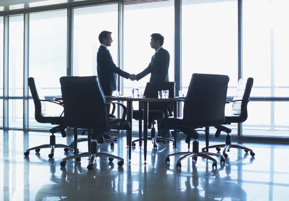 Men shaking hands in a conference room