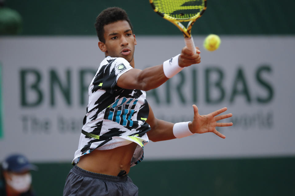 Canada's Felix Auger-Aliassime plays a shot against Japan's Yoshihito Nishioka in the first round match of the French Open tennis tournament at the Roland Garros stadium in Paris, France, Monday, Sept. 28, 2020. (AP Photo/Christophe Ena)