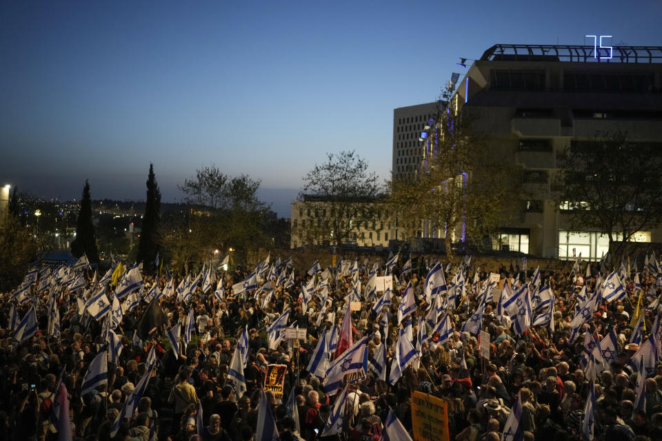 People take part in a protest against Israeli Prime Minister Benjamin Netanyahu's government and call for the release of hostages held in the Gaza Strip by the Hamas militant group outside of the Knesset, Israel's parliament, in Jerusalem, Sunday, March 31, 2024. Tens of thousands of Israelis gathered outside the parliament building in Jerusalem on Sunday, calling on the government to reach a deal to free dozens of hostages held by Hamas and to hold early elections. (AP Photo/Leo Correa)
