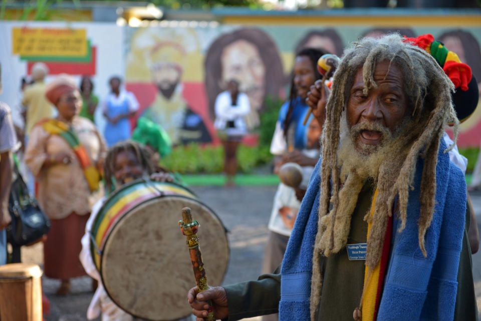 A Rastafarian priest leads a chant during the celebration of reggae music icon Bob Marley's 68th birthday in the yard of his Kingston home, in Jamaica, Wednesday, Feb. 6, 2013. Marley's relatives and old friends were joined by hundreds of tourists to dance and chant to the pounding of drums to honor the late reggae icon who died of cancer in 1981 at age 36. (AP Photo/ David McFadden)