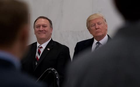 Donald Trump, accompanied by Michael Pompeo, left, before speaking at the Central Intelligence Agency in Langley, in January - Credit: AP