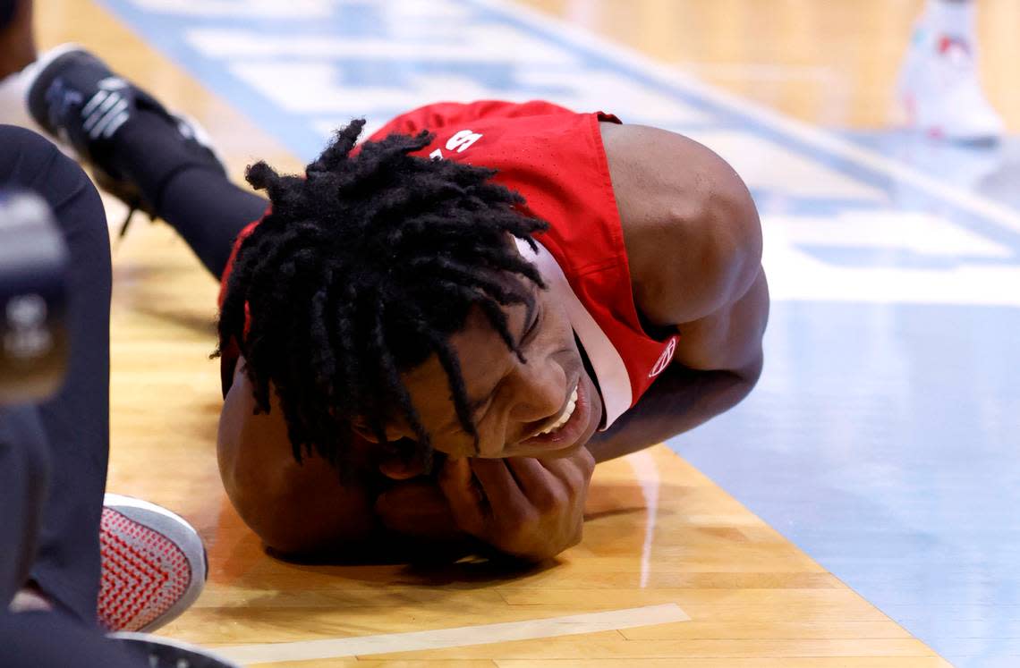 N.C. State’s Terquavion Smith (0) is in pain after landing hard during the second half of N.C. State’s game against UNC at the Smith Center in Chapel Hill, N.C., Saturday, Jan. 21, 2023. Smith was stretchered off.