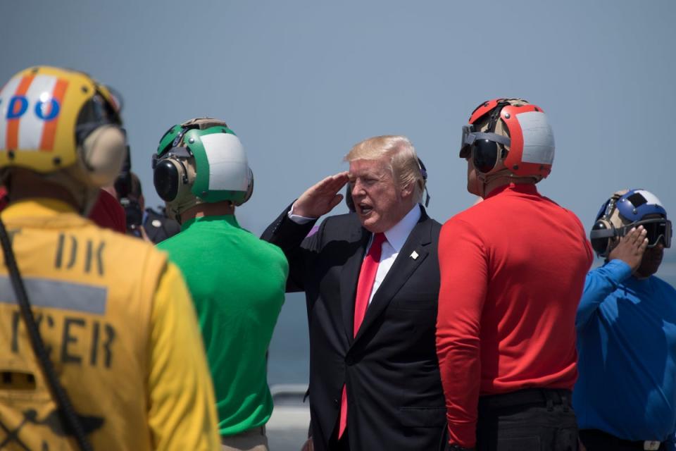Donald Trump (3rd R) salutes as he departs the USS Gerald R. Ford in Norfolk, Virginia, on July 22, 2017 (AFP via Getty Images)