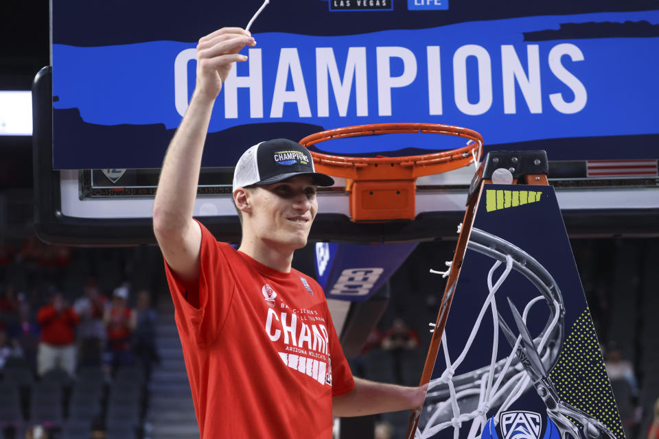 Arizona forward Azuolas Tubelis holds up a piece of the net after the team's win over UCLA in an NCAA college basketball game for the championship of the men's Pac-12 Tournament on Saturday, March 11, 2023, in Las Vegas. (AP Photo/Chase Stevens)