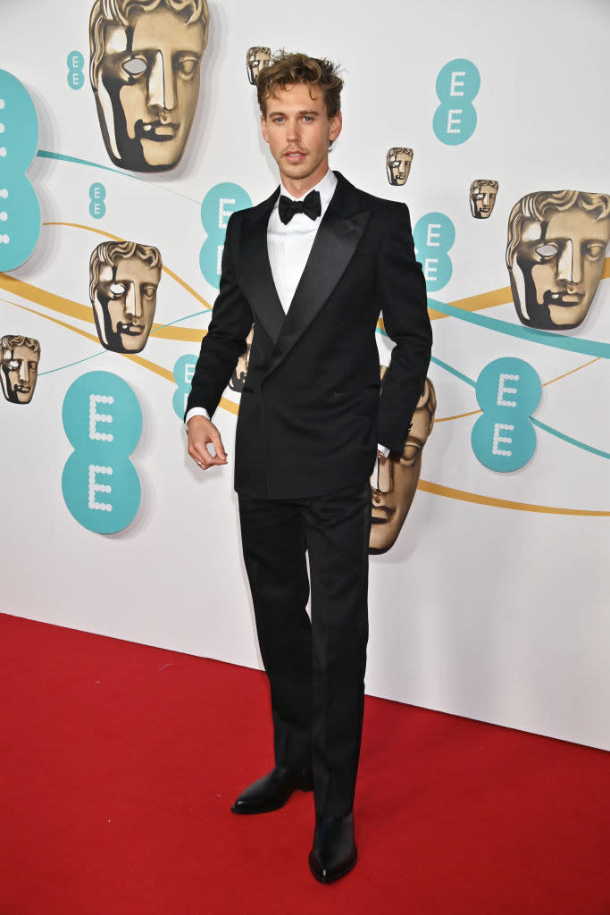 Austin Butler arrives at the EE BAFTA Film Awards 2023 at The Royal Festival Hall in a tradtional suit