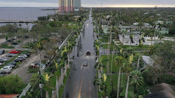 PHOTO: Vehicles make their way through a flooded area after Hurricane Ian passed through the area on Sept. 29, 2022 in Fort Myers, Fla. (Joe Raedle/Getty Images)