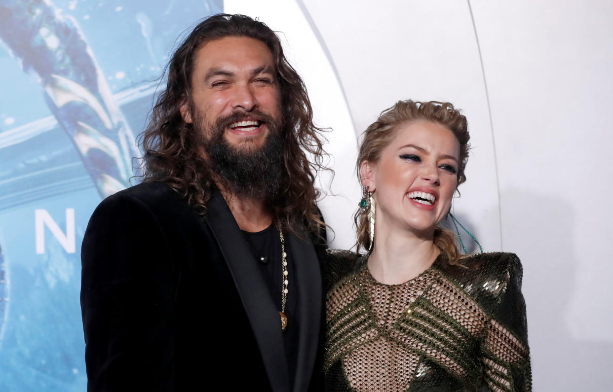 Jason Momoa and Amber Heard pose at the premiere of Aquaman on December 12, 2018.