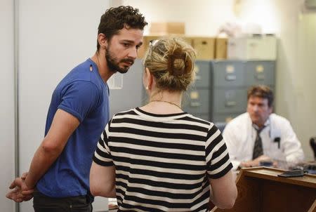 Shia LaBeouf (L), is arraigned in Midtown Community Court in New York June 27, 2014. REUTERS/Anthony DelMundo/Pool