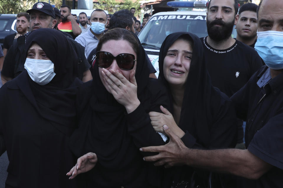 Family of Hassan Jamil Nehmeh mourn during his funeral processions in the southern Beirut suburb of Dahiyeh, Lebanon, Friday, Oct. 15, 2021. The government called for a day of mourning following the armed clashes, in which gunmen used automatic weapons and rocket-propelled grenades on the streets of the capital, echoing the nation’s darkest era of the 1975-90 civil war. (AP Photo/Bilal Hussein)