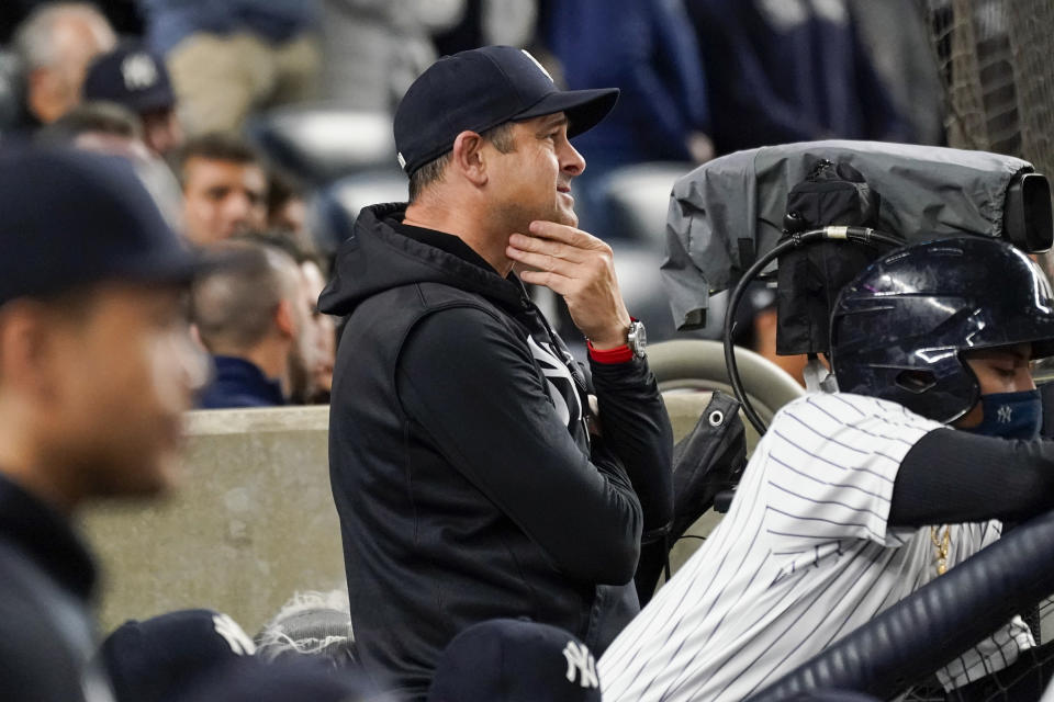 New York Yankees manager Aaron Boone watches the game from the dugout in the seventh inning of a baseball game against the Tampa Bay Rays, Friday, Oct. 1, 2021, in New York. (AP Photo/Mary Altaffer)