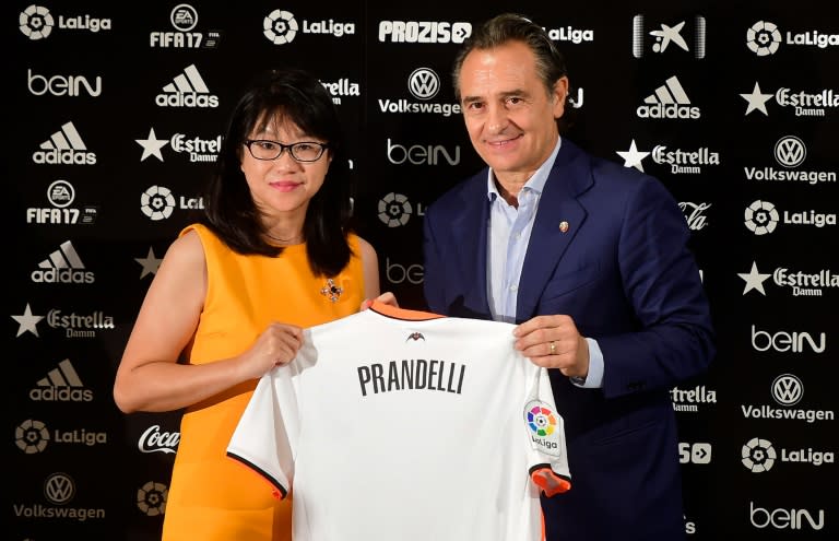 Cesare Prandelli (R) with Valencia's Singaporean President Lay Hoon Chan at the Mestalla stadium in Valencia on October 3, 2016