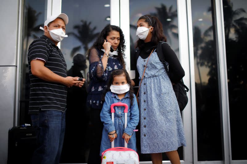 A family of travelers react after El Salvador's President Bukele ordered the closing of the airport in San Luis Talpa