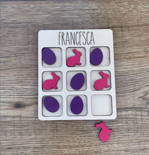 <p>Crafted out of solid wood, this adorable tic tac toe set can be customized in so many ways. Not only can you add personalization, you can customize the color of the board and the pieces. This gift will provide hours of entertainment.</p><p><em><a href="https://go.skimresources.com?id=113896X1572730&xs=1&url=https%3A%2F%2Fwww.etsy.com%2Flisting%2F927526784%2Fpersonalized-easter-tic-tac-toe-bunny%3Fga_order%3Dmost_relevant%26ga_search_type%3Dall%26ga_view_type%3Dgallery%26ga_search_query%3Deaster%26ref%3Dsr_gallery-1-35%26frs%3D1%26pop%3D1%26organic_search_click%3D1&sref=parade.com%2Fshopping%2Feaster-gifts-teens" rel="noopener" target="_blank" data-ylk="slk:Personalized Easter Tic Tac Toe Bunny and Eggs, Starting at $12.99 at Etsy;elm:context_link;itc:0;sec:content-canvas" class="link ">Personalized Easter Tic Tac Toe Bunny and Eggs, Starting at $12.99 at Etsy</a></em></p><p>Etsy</p>