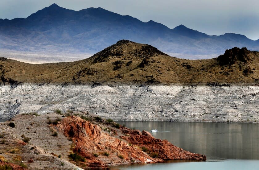 June 11: A boat navigates Lake Mead, where a white "bathtub ring" along the shore shows how far below capacity the nation's largest reservoir currently is. Water levels at Lake Mead have hit their lowest points in history amid an ongoing megadrought, creating uncertainty about the water supply for millions of people in the Western United States. (Luis Sinco / Los Angeles Times)