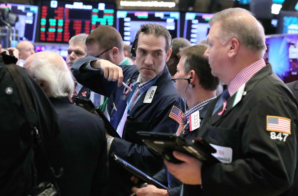 Traders work on the floor at the New York Stock Exchange (NYSE) in New York City, U.S., November 30, 2018. REUTERS/Brendan McDermid