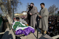Kashmiri villagers offer prayers near the body of Murtaza, a 14-year-old civilian, in Pulwama, south of Srinagar, Indian controlled Kashmir, Saturday, Dec. 15, 2018. At least seven civilians were killed and nearly two dozens injured when government forces fired at anti-India protesters in disputed Kashmir following a gunbattle that left three rebels and a soldier dead on Saturday, police and residents said. (AP Photo/ Dar Yasin)