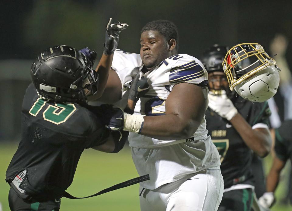 St. Vincent-St. Mary's Shawntei Lodge, left, knocks the helmet from Hoban's Keyshawn Haynes in the third quarter, Friday, Sept. 25, 2020.