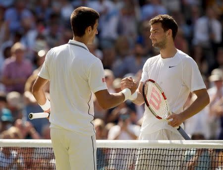 Jul 4, 2014; London, United Kingdom; Grigor Dimitrov (BUL) and Novak Djokovic (SRB) shake hands at the net after their match on day 11 of the 2014 Wimbledon Championships at the All England Lawn and Tennis Club. Susan Mullane-USA TODAY Sports