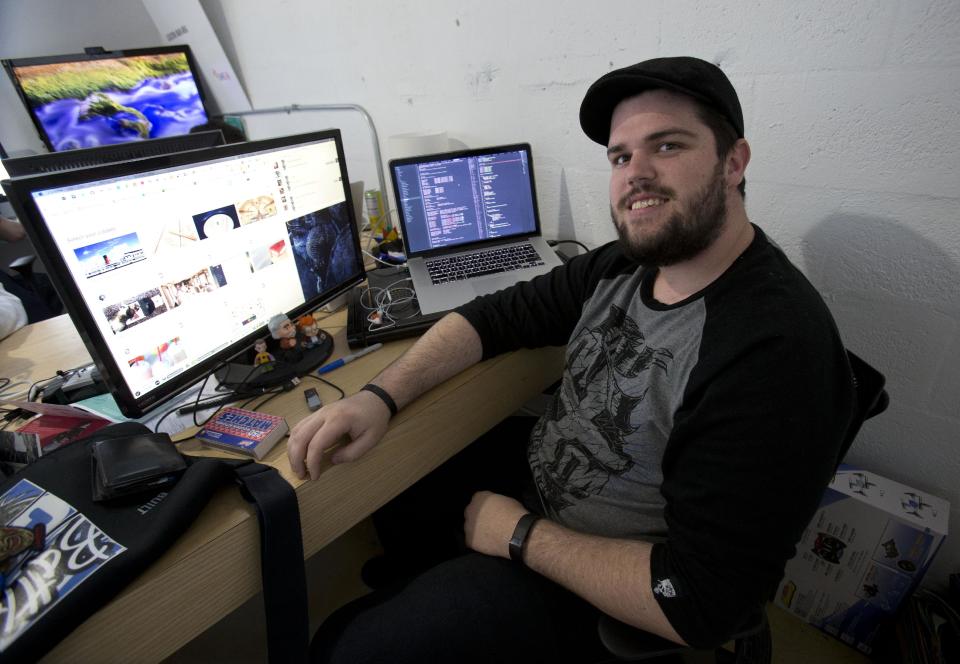 In this Thursday, Jan. 30, 2014 photo, web developer Jose Pimienta is shown in Miami. Pimienta will participate in the first “Hackathon for Cuba,” hosted by Roots of Hope, in Miami, bringing together web developers, programmers and others to brainstorm ways to help improve connectivity on the island. Cuba is considered the least connected country in the Western hemisphere. Last year, authorities opened more than 100 cyber-cafes around the island, but the price of $4.50 an hour is still exorbitant for the average Cuban making $20 a month. (AP Photo)